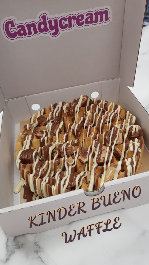 Warm waffle topped with milk chocolate sauce, and white chocolate drizzle from 
Candy Cream dessert shop in Bathgate 