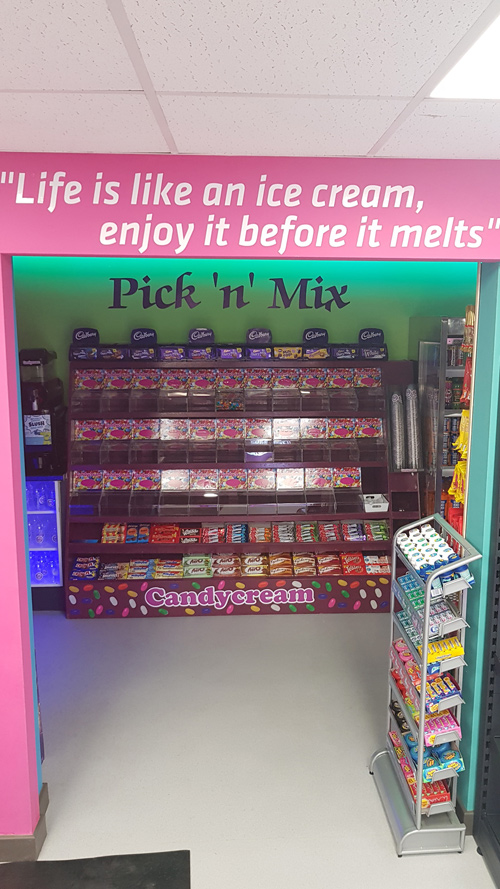 Colourful Pick 'n' Mix candy display wall inside the Candy Cream dessert shop in 
Bathgate 